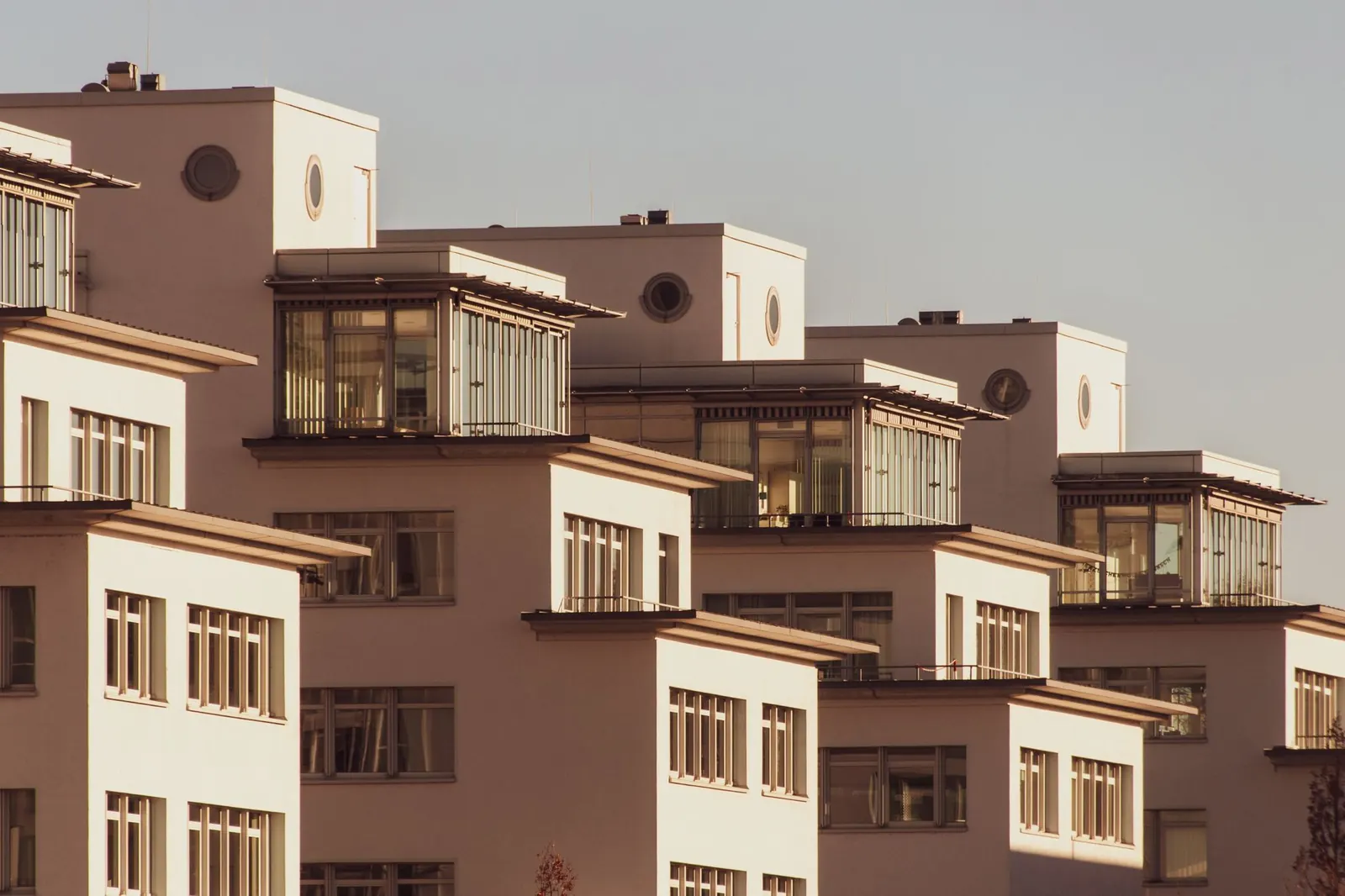 Warm-toned apartment blocks with terraces in evening sun